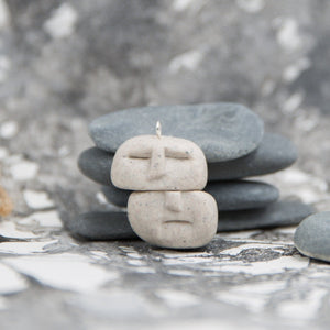 Two balancing stones pendant in stone and grey artistic background
