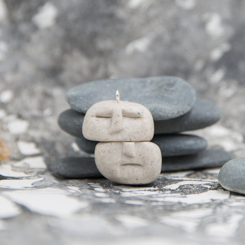 Two balancing stones pendant in stone and grey artistic background