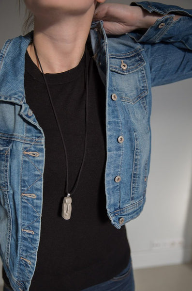 Easter island moai pendant on girl wearing black shirt and blue jeans jacket 