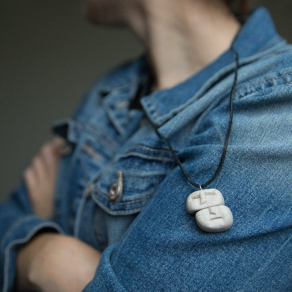 Pendant made from polymer clay on girl's  blue jeans jacket shoulder